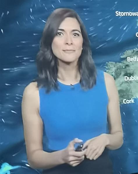 A Woman Standing In Front Of A Weather Map