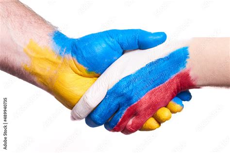 Flags Of Ukraine And Russia Flag On Hands Isolated On White Background