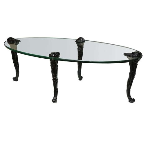 Get 50% off retail prices & free shipping on all orders! P. E Guerin Oval Glass Coffee Table With Black Carved Wood ...