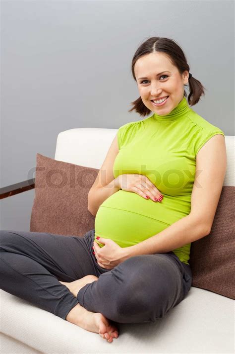 Beautiful Smiley Pregnant Woman Sitting On Sofa Stock Image Colourbox