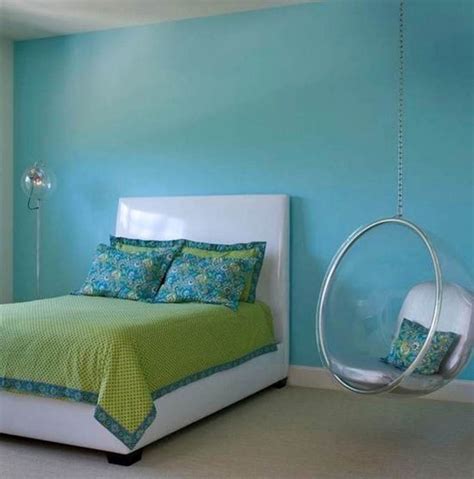 Unique and comfortable approach to a relaxation spot in a bedroom furnished with a large indoor hanging chair. bedroom swings in blue room