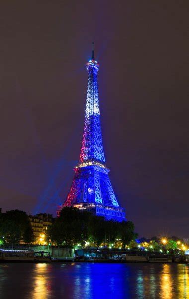 The Eiffel Tower Lit Up In Color Of French Flag Paris France Stock