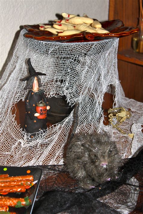 A Table Topped With Halloween Decorations And Plates Filled With