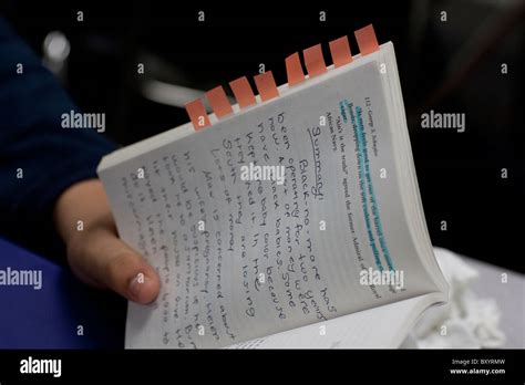 Student Holds Copy Of Novel With Highlighted Text Handwritten Notes