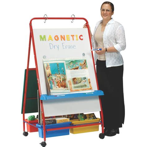 A Woman Standing In Front Of A Magnetic Dry Erase Board And Easel With