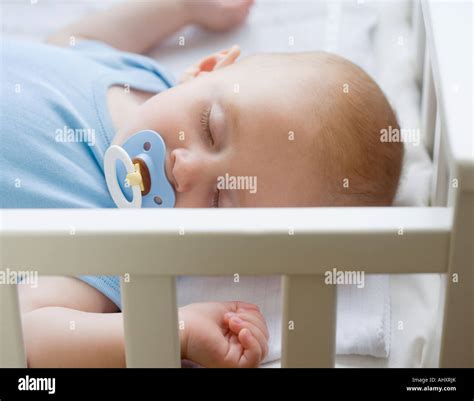 Baby Sleeping In Crib Stock Photo Alamy