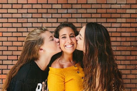 Two Girls Kissing Their Happy Best Friend By Stocksy Contributor Victor Torres Stocksy