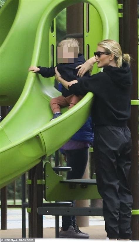 Rosie Huntington Whiteley Attends To Her Son Jack On The Slide As They