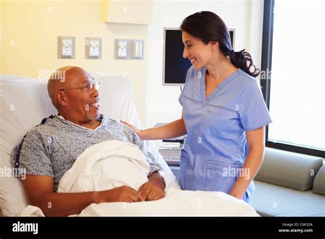 Nurse Talking To Senior Male Patient In Hospital Room Stock Photo Alamy