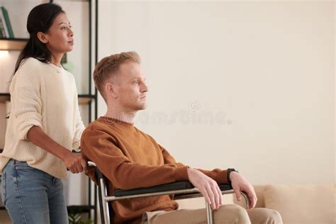 Caregiver Pushing Patient In Wheelchair Stock Image Image Of Push