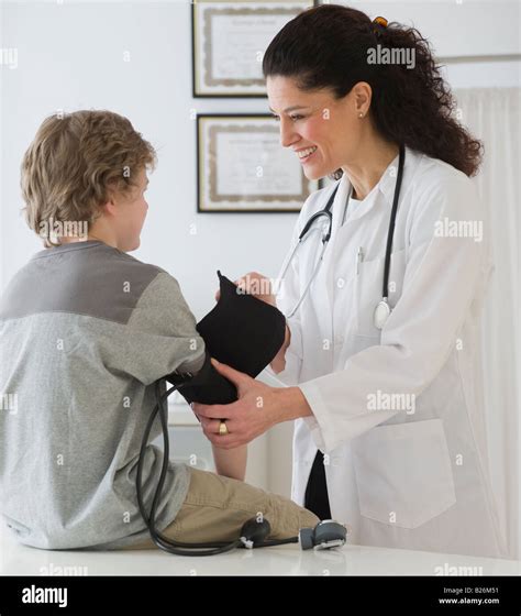Hispanic Female Doctor Taking Childs Blood Pressure Stock Photo Alamy