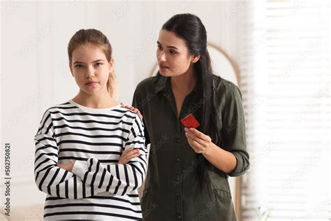 Mother Talking With Her Teenage Daughter About Contraception At Home Sex Education Concept