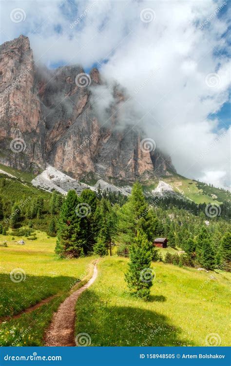 Picturesque Path On A High Alpine Meadow With Misty Peaks Of Italian
