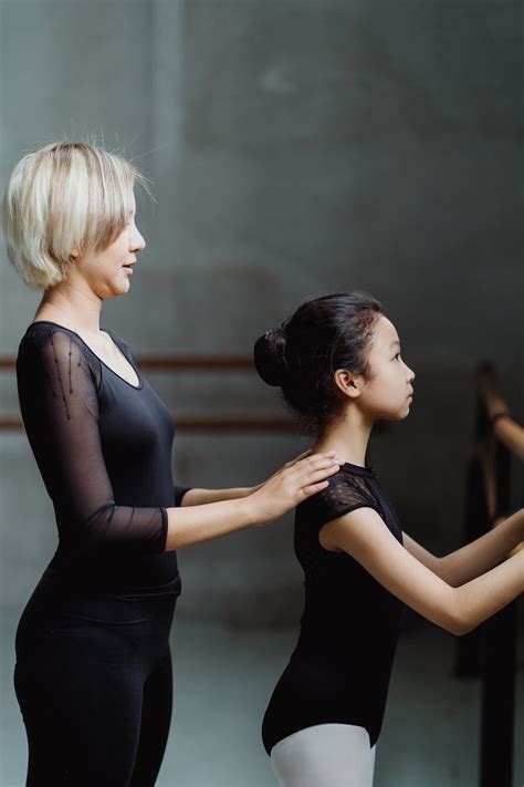 Young Ballet Teacher Helping Beginner Little Dancer In Studio · Free
