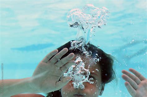 A Girl Holding Her Breath While Swimming Underwater By Alicia Bock