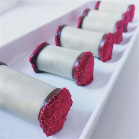Four Pieces Of Red Velvet Covered Dessert On A White Plate With
