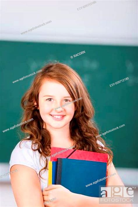 Close Up Portrait Of A Smiling Pretty Brunette Schoolgirl Holding Her