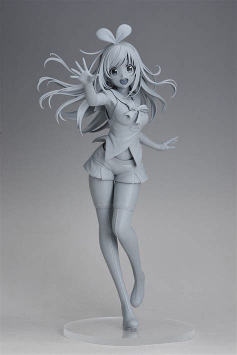 A Plastic Figurine That Is Standing On A White Base With Her Arms Outstretched