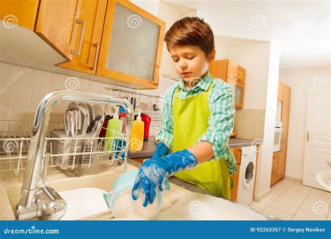 Boy Doing The Dishes Under Running Water In Sink Stock Image Image Of