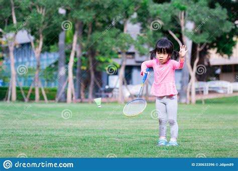 Asian Cute Girl Playing Badminton On Wet Green Grass Sport Girl Stock