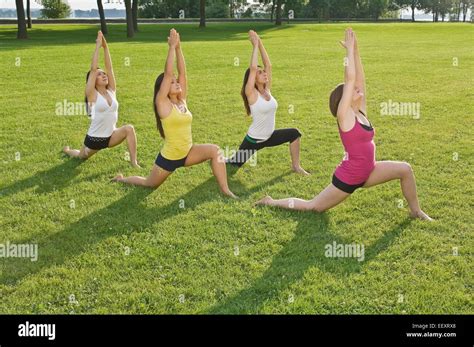 Four Women Doing Yoga In A Park Stock Photo Alamy