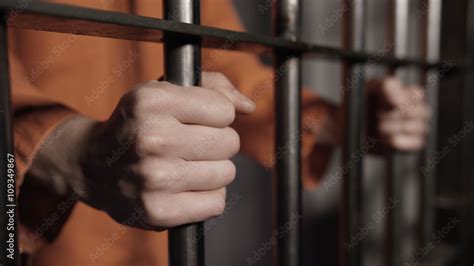 Man In Jail Hands On Cell Bars Of Prison Stock Photo Adobe Stock