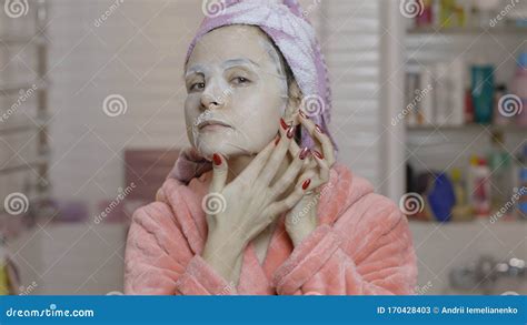 Woman Applying Cosmetic Face Mask In Bathroom Skincare Spa Facial