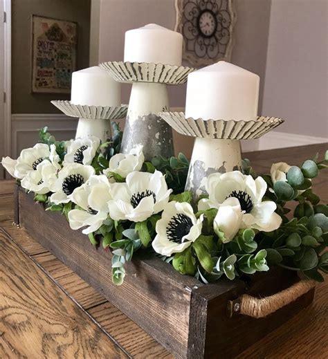 Some White Flowers And Candles Are In A Wooden Box On A Table With Wood