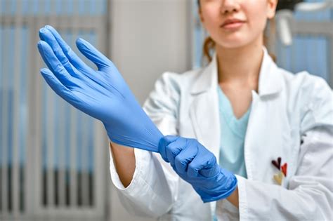 Premium Photo Close Up Of A Female Doctor Putting A Blue Latex Gloves