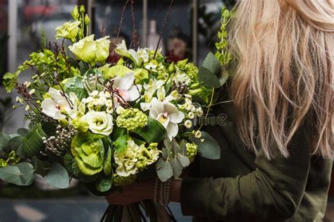 Female Hands Holding Green Bouquet Of Bronica Brassica Orchid