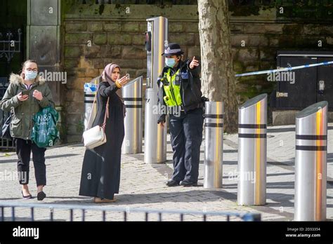 West Midlands Female Police Constable Gives A Lady Directions Around A