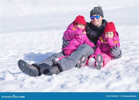 Happy Father Sitting In Snow With His Two Daughters Stock Image Image