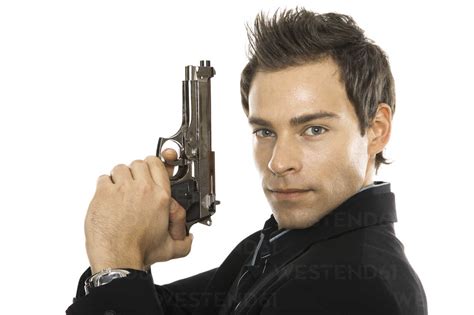 Young Man Holding Hand Gun Close Up Stock Photo