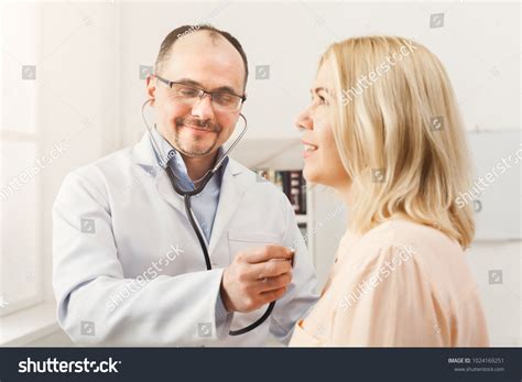 Happy Doctor Stethoscope Checking Patient Heart Stock Photo 1024169251