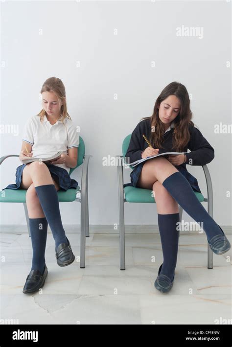 Two Girls Wearing Uniforms Sit On Chairs Doing School Work Benalmadena Costa Malaga Andalusia