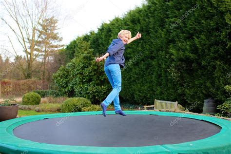 Happy Boy Jumping On Trampoline — Stock Photo © Cromary 113827490