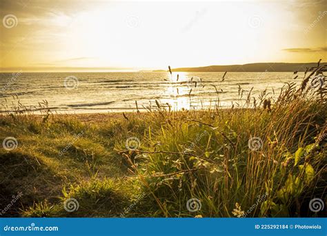 Sunset Over The Ocean In Tenby Wales Uk Summer Landscape Stock Photo