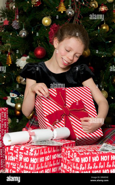 Girl Opening Christmas Presents Stock Photo Alamy