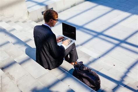 Smart Businessman Using Laptop For His Work Outdoor Sitting On The