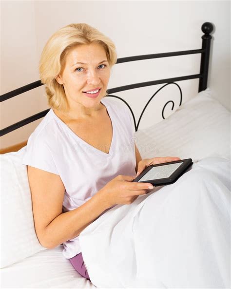 Mature Woman With Ebook Laying In Bed Stock Image Image Of Cheerful Femininity
