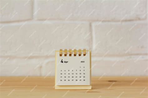 Premium Photo Desktop Calendar For April 2022 For Planning On The Table