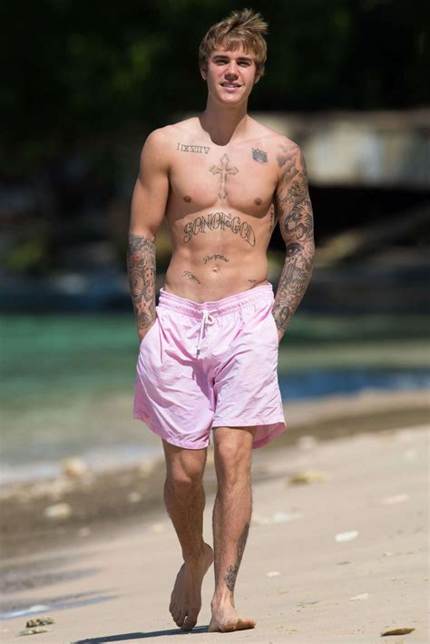 justin bieber looks buff while taking a shirtless beachside stroll in barbados