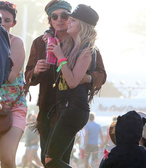 two women standing next to each other in front of a crowd at a music festival