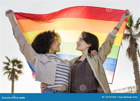 Young Lesbian Girls Hugging And Waving A Gay Flag Stock Image Image