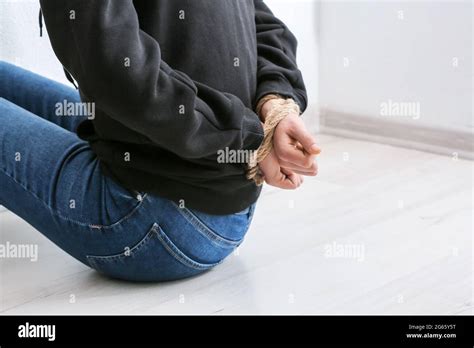 Female Hostage With Tied Hands Sitting On Floor In Room Stock Photo Alamy