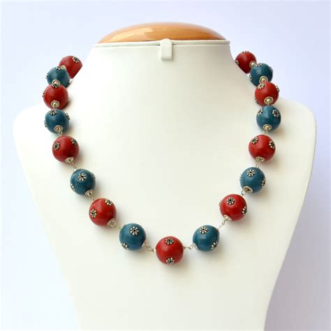 Handmade Necklace With Red And Blue Beads Having Metal Flowers Maruti Beads