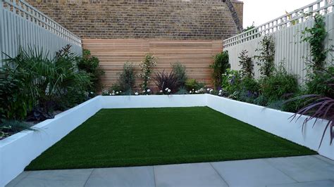 Want to transform your small garden in just a weekend? Sawn grey sandstone paving raised rendered beds hardwood ...