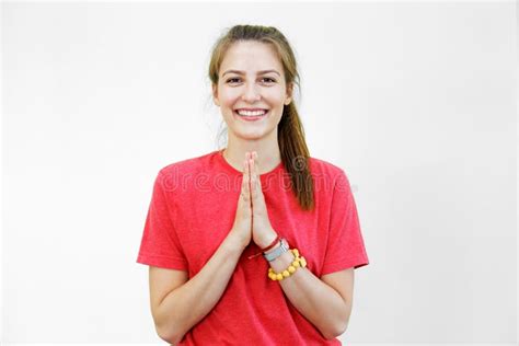 Young Smiling Woman Holding Hands In Namaste Or Prayer Stock Photo