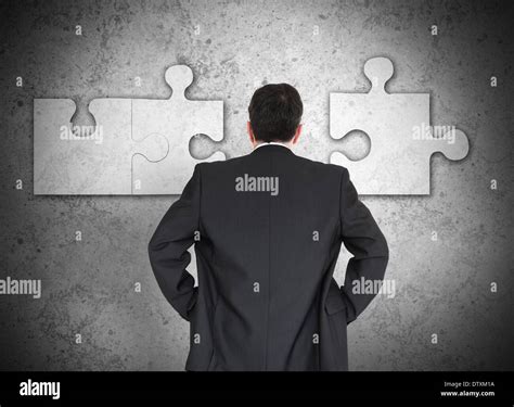 Businessman Figuring Out Puzzle Stock Photo Alamy