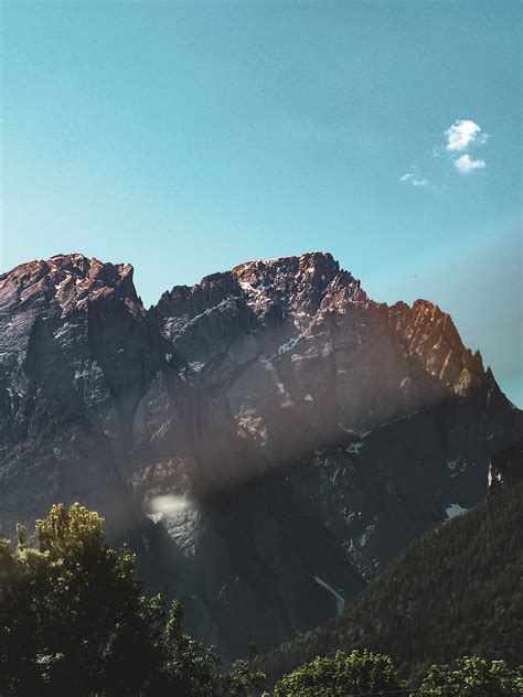 Brown Rocky Mountain Under Blue Sky During Daytime Hd Phone Wallpaper